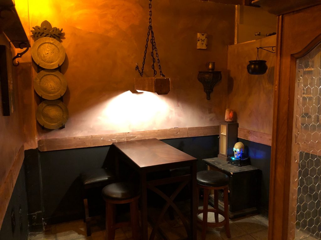 Warm and inviting, this space includes a bar height table for 4 or 5, and a distinctly medieval flavor. A warm and friendly place to play Board Games